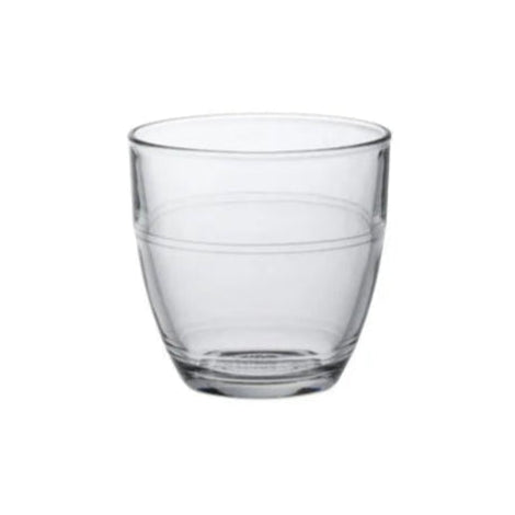 A clear glass tumbler with a simple design, showing vertical seams where the glass is constructed from multiple pieces.