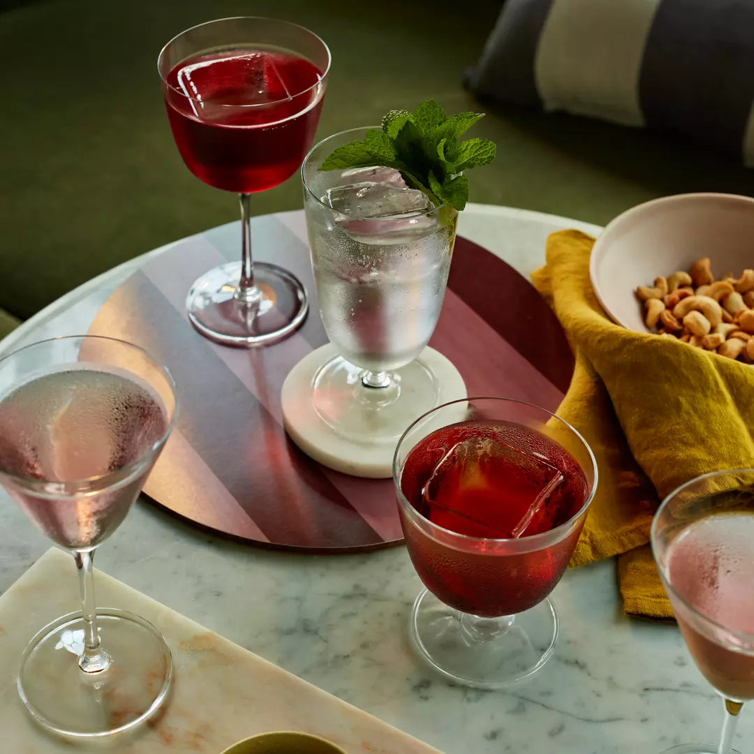 Assorted cocktails glassware presented on a table setting