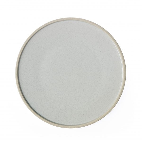 Round white plate with pebble speckle on a white background