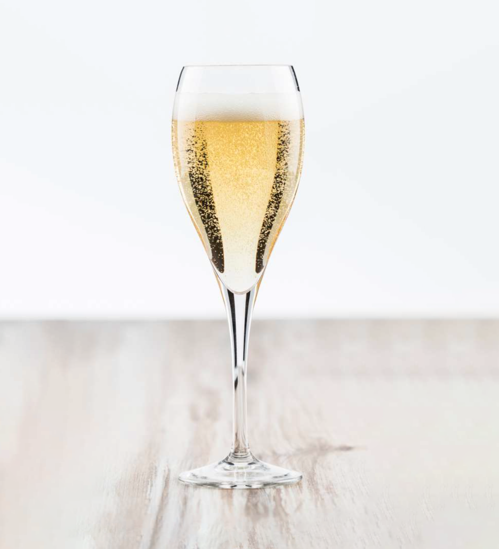 A standard sized champagne fulte with sparkly liquid on a white background