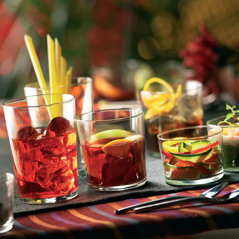 Four decorated Tumblers on a table setting 