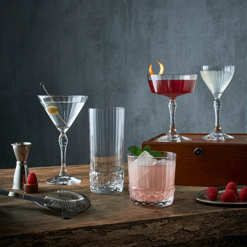 Assorted beverages in different glasses on a wooden surface with a dark background