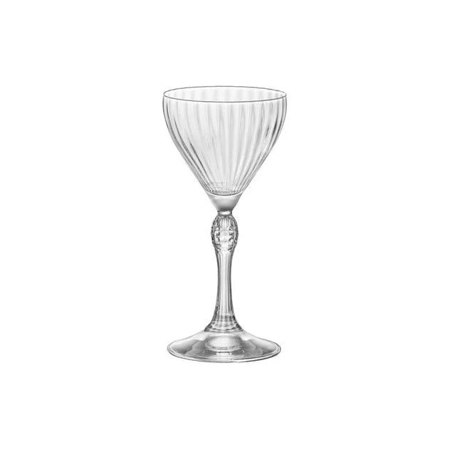 Old style stemmed cocktail glass with ripples presented on a white background