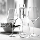 Set of clear wine glasses on a light surface with a blurred background
