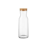 Clear glass carafe with a wooden lid on a white background