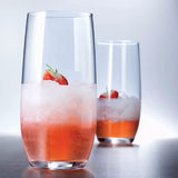 Two glasses of strawberry juice with ice on a reflective surface