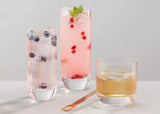 Three glasses of different drinks on a light gray background