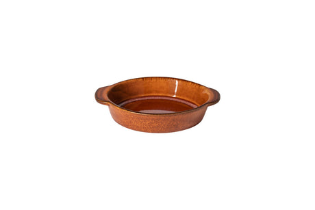 Caramel coloured gratin dish on white background