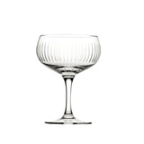 A clear glass cocktail cup with vertical cut lines pattern, stem included, against a white background.