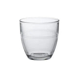 A clear glass tumbler with a simple design, showing vertical seams where the glass is constructed from multiple pieces.