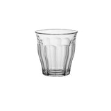 A clear glass tumbler with a textured, vertically fluted pattern, centered on a solid white background.