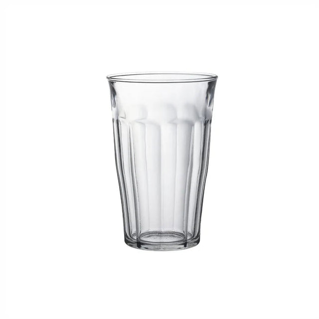 A clear ribbed glass tumbler centered on a plain white background.