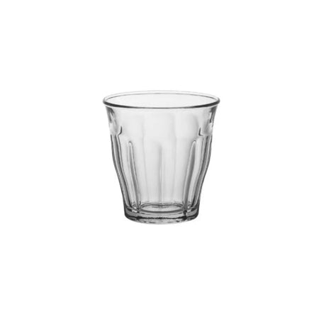 A clear glass tumbler with a textured pattern.