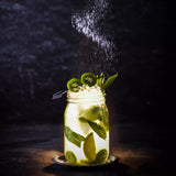 Drinking Jar with liquid and fruit on blue grey background