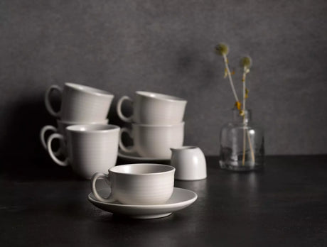 Coffee cups and saucers on a grey background
