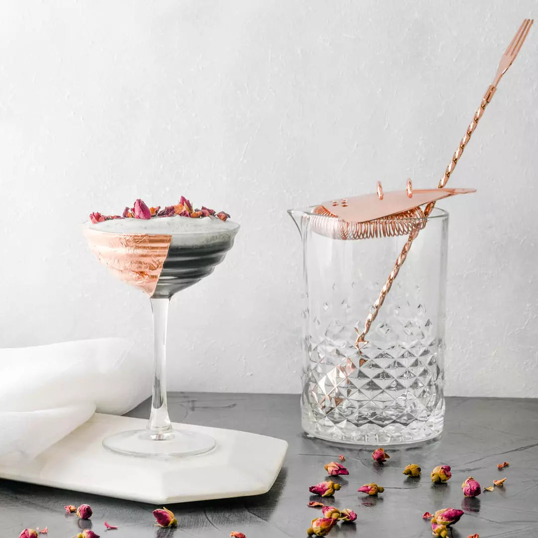 Two cocktails with decorative elements on a light background