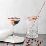 Two cocktails with decorative elements on a light background