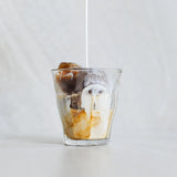 Glass of iced coffee with a white background