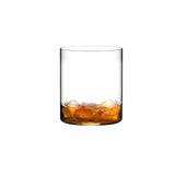 Small whiskey tumbler with brown liquid on a white background