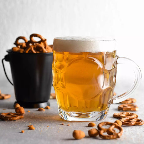 Dimple beer mug with handle and liquid on white background