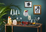 8 different glasses on a table with a blue background