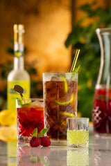 Geometric glasses with various liquids on orange background