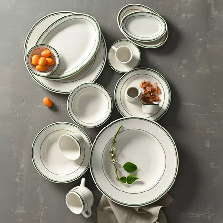 Set of ceramic plates and bowls on a gray surface
