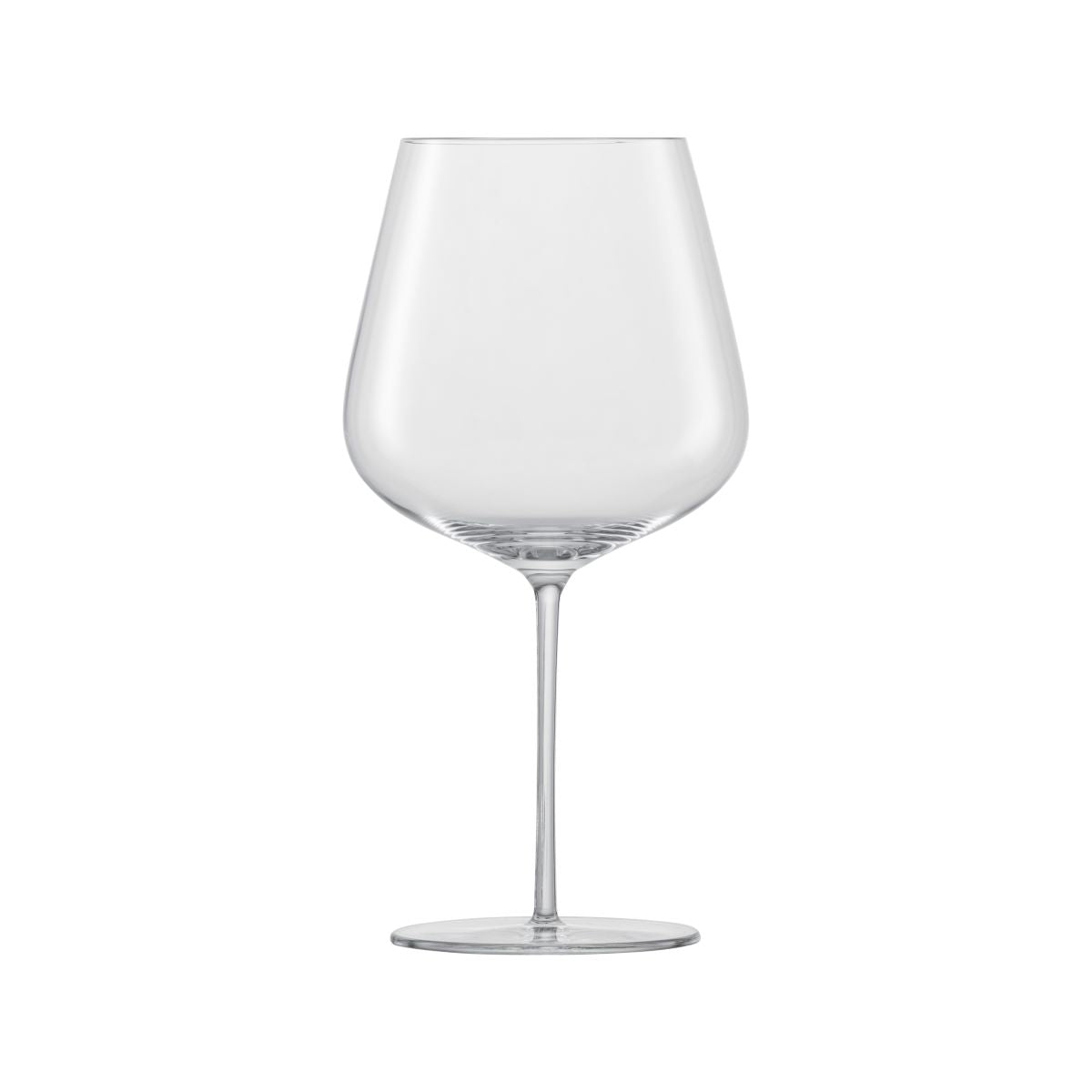 A large clear red wine glass on a white background