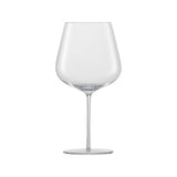 A large clear red wine glass on a white background
