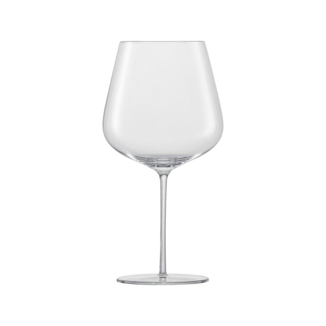 A large clear red wine glass on a white background
