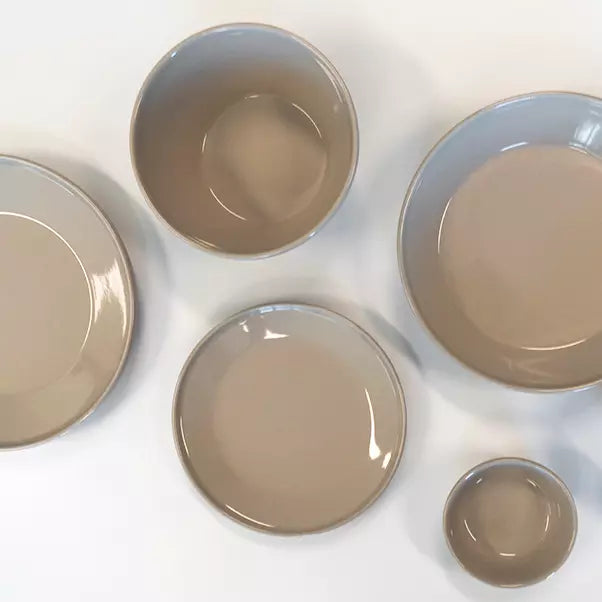 A set of five ceramic plates and bowls in a matching glossy taupe-brown glaze, arranged on a clean white background.