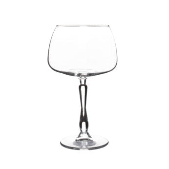 Clear gin and tonic glass on a white background