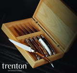 Set of knives in a wooden box with 'trenton international' branding.