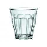 A clear glass tumbler with a textured pattern.