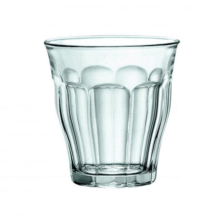 A clear glass tumbler with a textured pattern.