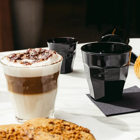 Medium sized tumbler showing a cafe late on a table setting with black plastic tumblers in background on a table setting