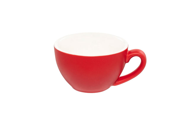 A red ceramic cappuccino cup with a white interior and handle on the side, against a white background.