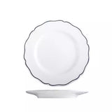 Small round wide rimmed scalloped white plate with a blue band around the ourtside