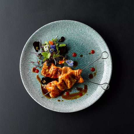 Chicken skewers on jade green plate