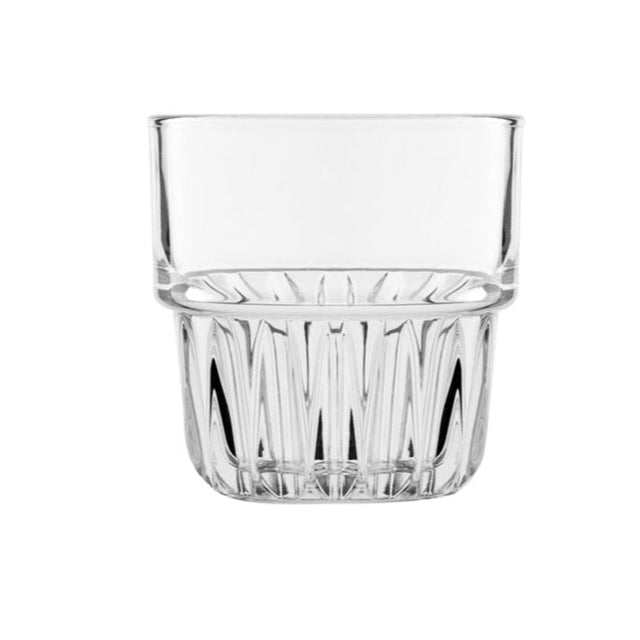 Clear tumbler  glass with rippled bottom on white background