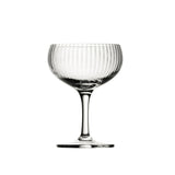 A clear, lined champagne coupe presented on a white background