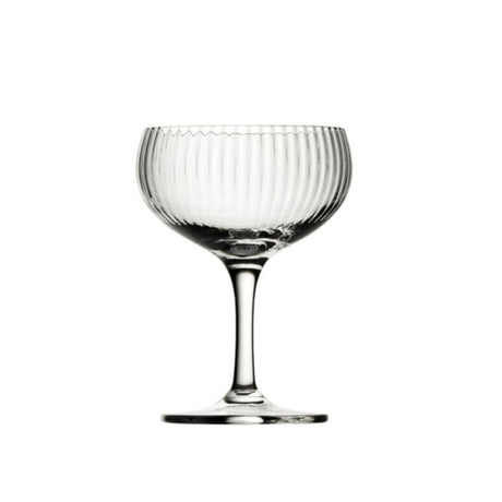 A clear, lined champagne coupe presented on a white background