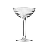 Clear cocktail glass with swirls on white background