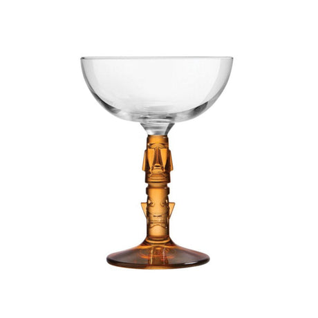A clear glass coupe with an amber-colored stem, designed for serving cocktails.