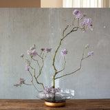 Bowl display with flowers on wooden bench