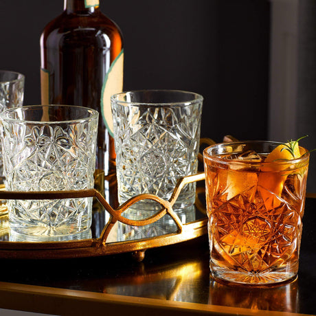 Crystal cut glasses with liquid on bar
