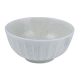 A round porcelain bowl with scallop edges and a muted color palette of grey, green, and white.